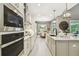 Eat-in kitchen with built in oven, pendant lighting, and adjacent dining area at 12707 Green Heron Way, Odessa, FL 33556