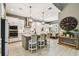 Modern kitchen with a center island, stainless steel appliances, and bar stool seating at 12707 Green Heron Way, Odessa, FL 33556