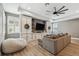 Cozy living room with built-in cabinets, large sectional, and a ceiling fan at 12707 Green Heron Way, Odessa, FL 33556