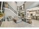 Open living area with a staircase, sectional sofa, and views of the kitchen and dining area at 12707 Green Heron Way, Odessa, FL 33556
