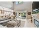Bright living area featuring a stone fireplace, an open floor plan, and access to outdoor patio at 12707 Green Heron Way, Odessa, FL 33556