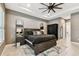 Primary bedroom featuring a dark wood bed frame, tray ceilings, and ensuite bath at 12707 Green Heron Way, Odessa, FL 33556