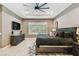 Primary bedroom with a dark wood bed frame, tray ceilings, and a dresser at 12707 Green Heron Way, Odessa, FL 33556