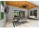 Stylish outdoor dining area with a wood ceiling, ceiling fan, and designer furniture for upscale entertaining at 12707 Green Heron Way, Odessa, FL 33556