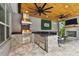 Gourmet outdoor kitchen boasts modern appliances, stone accents, and a cozy fireplace for year-round enjoyment at 12707 Green Heron Way, Odessa, FL 33556