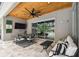 Enjoy the outdoor living space with ceiling fan, TV, comfortable seating and dining table at 12707 Green Heron Way, Odessa, FL 33556