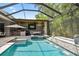 Stunning screened pool area with an outdoor kitchen and luxurious spa for ultimate relaxation and entertainment at 12707 Green Heron Way, Odessa, FL 33556
