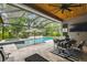 Beautiful outdoor living space featuring a screened pool, dining area, and lush green landscaping for privacy at 12707 Green Heron Way, Odessa, FL 33556