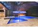 In-ground pool with hot tub and fire pit covered by a screened-in enclosure at 12707 Green Heron Way, Odessa, FL 33556