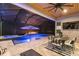 Inviting covered pool with an umbrella, fire pit, and outdoor dining under a wood-paneled ceiling at 12707 Green Heron Way, Odessa, FL 33556