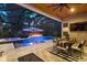 In-ground pool with hot tub and fire pit with outdoor dining and mounted TV at 12707 Green Heron Way, Odessa, FL 33556