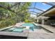 Enjoy the screened-in pool and spa with its stone surround and ample room for lounging at 12707 Green Heron Way, Odessa, FL 33556