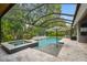 Gorgeous screened pool with a spa, landscaping, and plenty of space for relaxation and outdoor gatherings at 12707 Green Heron Way, Odessa, FL 33556
