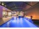 Stunning covered pool with waterfalls, a spa, and an outdoor lounge with a kitchen and bar at 12707 Green Heron Way, Odessa, FL 33556