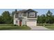 Charming two-story home features a craftsman-style facade, a two-car garage, and a well-manicured lawn at 13151 Empress Jewel Trl, Parrish, FL 34219