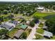 An aerial view of houses and the community reveals lush landscaping and green spaces at 14734 11Th St, Dade City, FL 33523