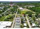 An aerial view of the neighborhood showcasing the homes and nearby commercial buildings at 14734 11Th St, Dade City, FL 33523