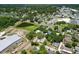An aerial view showing neighborhood homes and a small pond at 14734 11Th St, Dade City, FL 33523