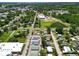 An aerial view of the neighborhood showcasing the homes and nearby commercial buildings at 14734 11Th St, Dade City, FL 33523