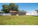 View of backyard and shed, enclosed by a white fence, with ample space for activities at 14734 11Th St, Dade City, FL 33523