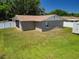 A backyard view with a shed provides a serene space for outdoor enjoyment and storage at 14734 11Th St, Dade City, FL 33523