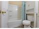Bathroom features a tub with shower, modern fixtures, and a toilet at 14734 11Th St, Dade City, FL 33523