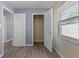 Bedroom with a spacious closet, new floors, and freshly painted walls at 14734 11Th St, Dade City, FL 33523