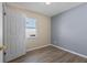 Cozy bedroom featuring modern flooring, fresh paint, and a bright window at 14734 11Th St, Dade City, FL 33523