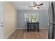 Cozy dining area with table and chairs next to the kitchen, featuring wood-look floors at 14734 11Th St, Dade City, FL 33523