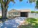 Charming single-story home features a large tree, screened in porch, and well-maintained lawn at 14734 11Th St, Dade City, FL 33523