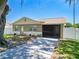Charming home featuring a driveway, a screen porch, and well-maintained landscaping at 14734 11Th St, Dade City, FL 33523