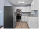 Modern kitchen features stainless steel appliances and white cabinets with granite counters at 14734 11Th St, Dade City, FL 33523