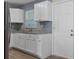 Updated kitchen with granite countertops, white cabinetry, and stainless steel appliances at 14734 11Th St, Dade City, FL 33523