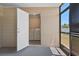Laundry room inside of the screened in patio, accessible from a doorway and glass door at 14734 11Th St, Dade City, FL 33523