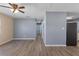Bright living room with new laminate flooring and ceiling fan is move-in ready at 14734 11Th St, Dade City, FL 33523