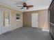 Covered patio with ceiling fan and ample space for outdoor furniture at 14734 11Th St, Dade City, FL 33523