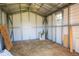 Spacious interior with plywood floor, white metal studs, and window, ready for storage at 14734 11Th St, Dade City, FL 33523