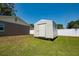 Backyard view of shed with white door and white siding provides extra storage at 14734 11Th St, Dade City, FL 33523