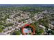 Aerial view showcasing a single-story home with mature trees, and the surrounding neighborhood at 1535 Nursery Rd # 107, Clearwater, FL 33756