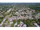 Panoramic aerial view of a residential neighborhood with tree-lined streets and diverse home styles at 1535 Nursery Rd # 107, Clearwater, FL 33756