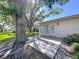 Backyard patio and exterior of the home with lush landscaping and blue skies at 1535 Nursery Rd # 107, Clearwater, FL 33756