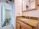 Bathroom with an undermount sink, granite countertop, and a wood cabinet at 1535 Nursery Rd # 107, Clearwater, FL 33756
