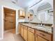 Bright bathroom features a double sink vanity with granite countertops and a glass shower at 1535 Nursery Rd # 107, Clearwater, FL 33756