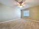 Bright bedroom with carpeted floors, a ceiling fan, and a window providing natural light at 1535 Nursery Rd # 107, Clearwater, FL 33756