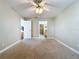 Neutral bedroom provides a calming atmosphere with cozy carpeting and ample natural light at 1535 Nursery Rd # 107, Clearwater, FL 33756