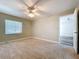 Bedroom featuring a ceiling fan, natural light, neutral paint, carpet flooring, and window at 1535 Nursery Rd # 107, Clearwater, FL 33756
