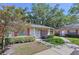 Beautiful property showcasing meticulous landscaping and walkway to entrance at 1535 Nursery Rd # 107, Clearwater, FL 33756