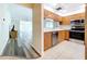 Open-concept kitchen featuring wood cabinets and stainless steel appliances at 1535 Nursery Rd # 107, Clearwater, FL 33756