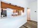 Granite countertop and wood cabinets in this open concept kitchen at 1535 Nursery Rd # 107, Clearwater, FL 33756