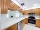 Bright kitchen with updated stainless steel appliances and wood cabinetry at 1535 Nursery Rd # 107, Clearwater, FL 33756